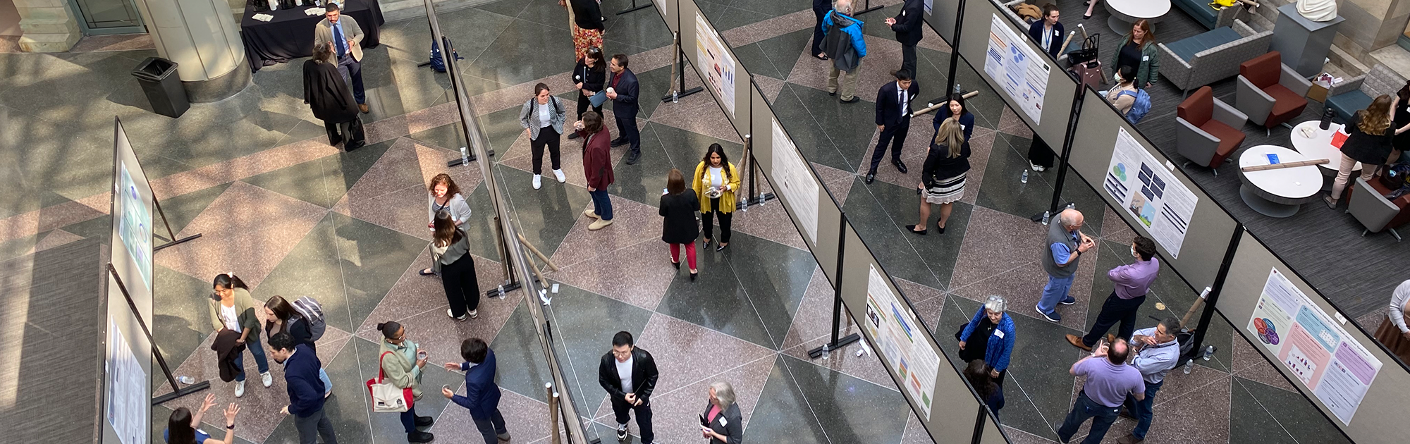 Overhead view of MBE students presenting posters at the capstone symposium.