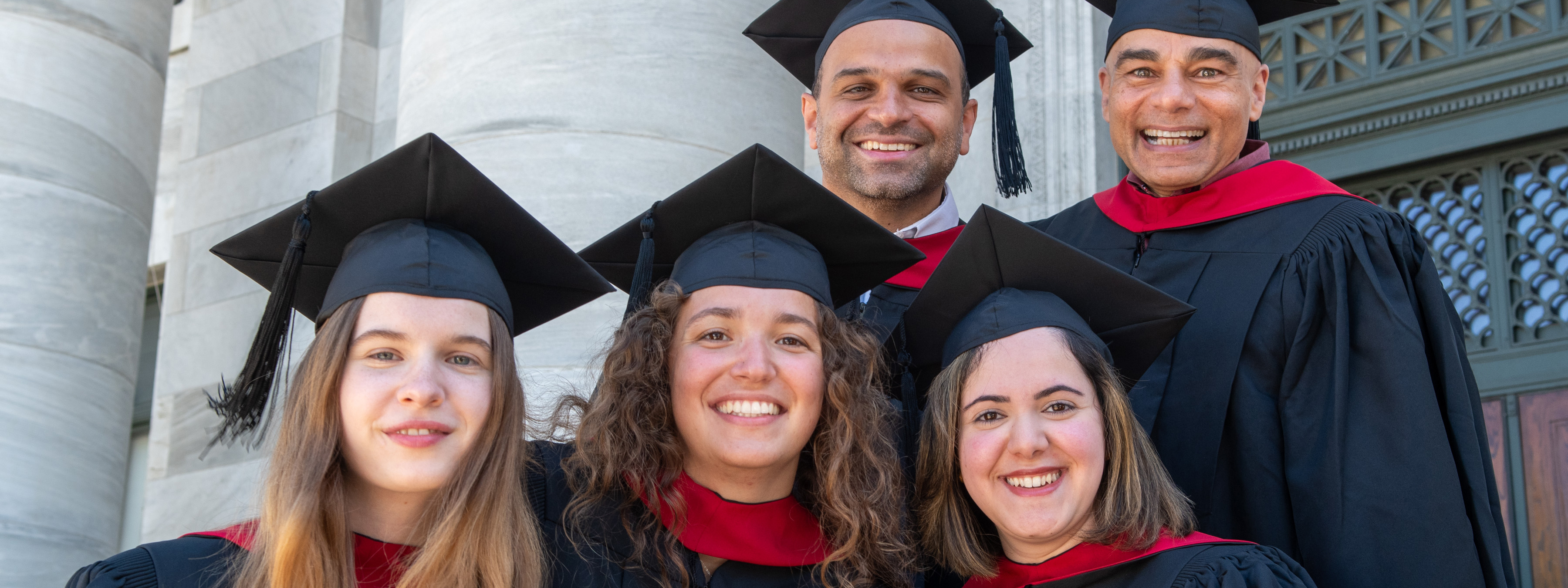 MBE graduates in gowns and caps.