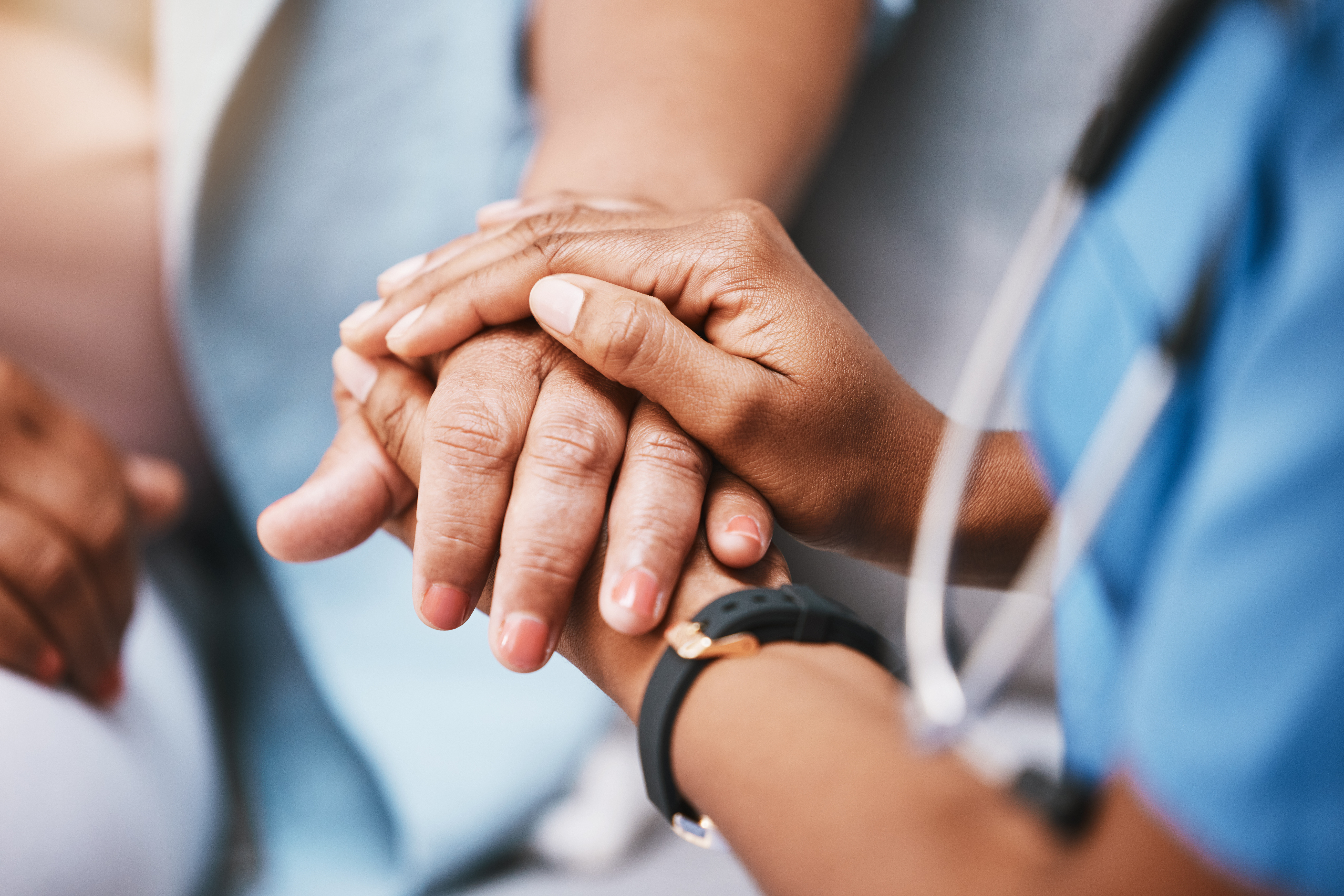 Nurse holding hands with patient.
