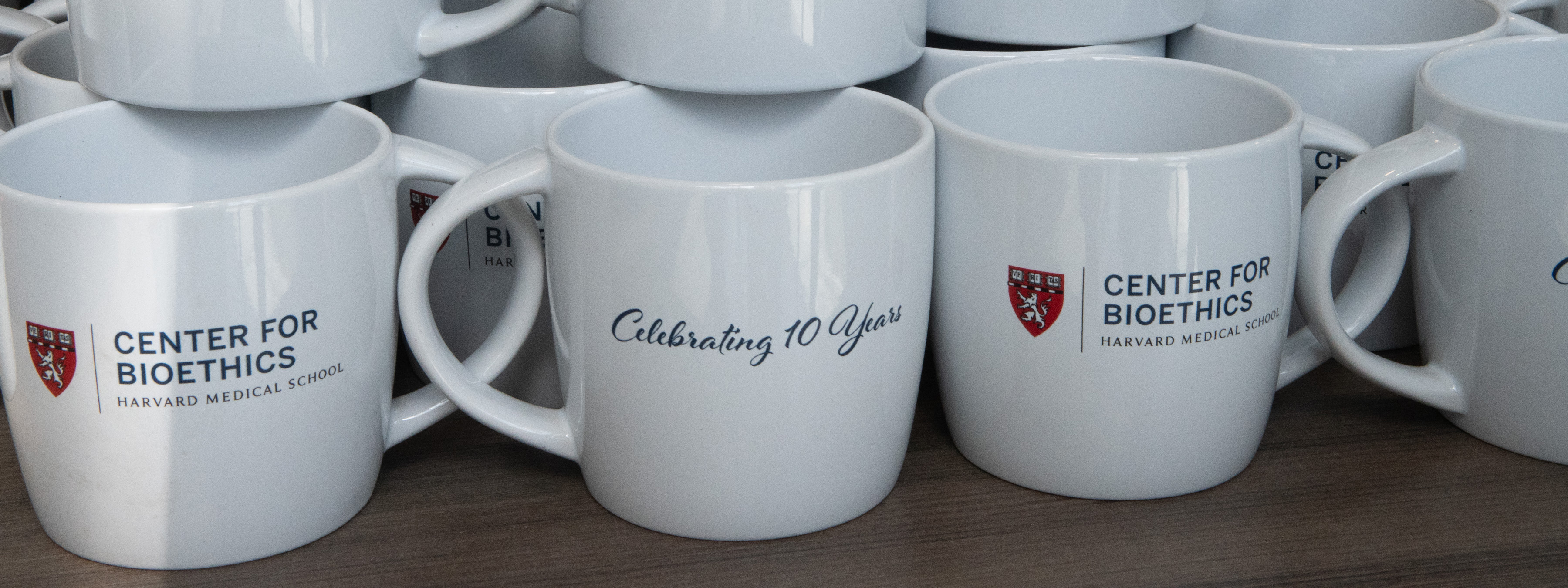Center-branded coffee mugs stacked together.