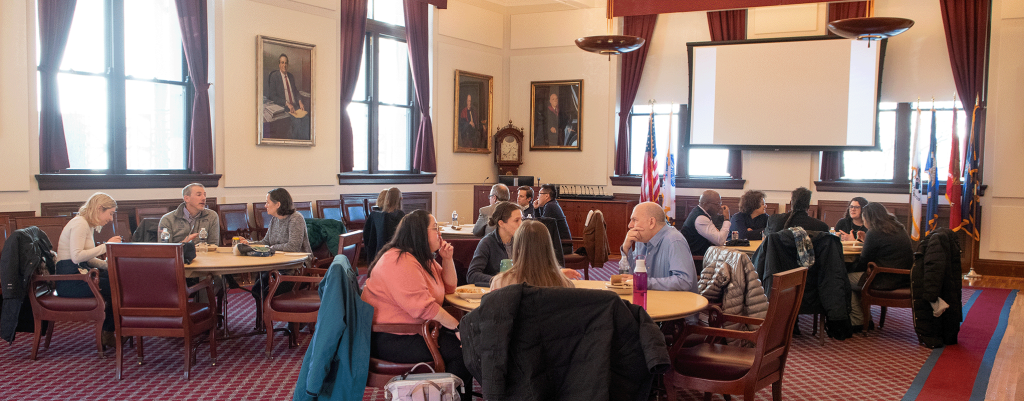 Fellows gathered around tables for lunch.