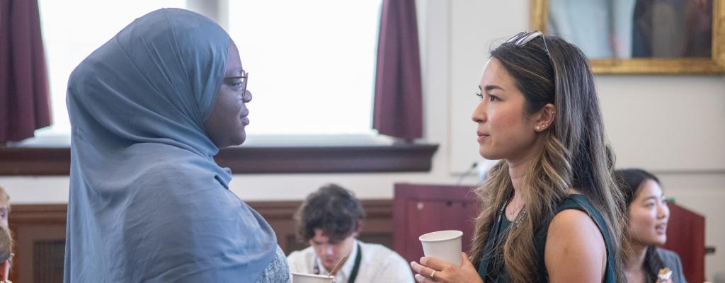 Two female students chatting during orientation.