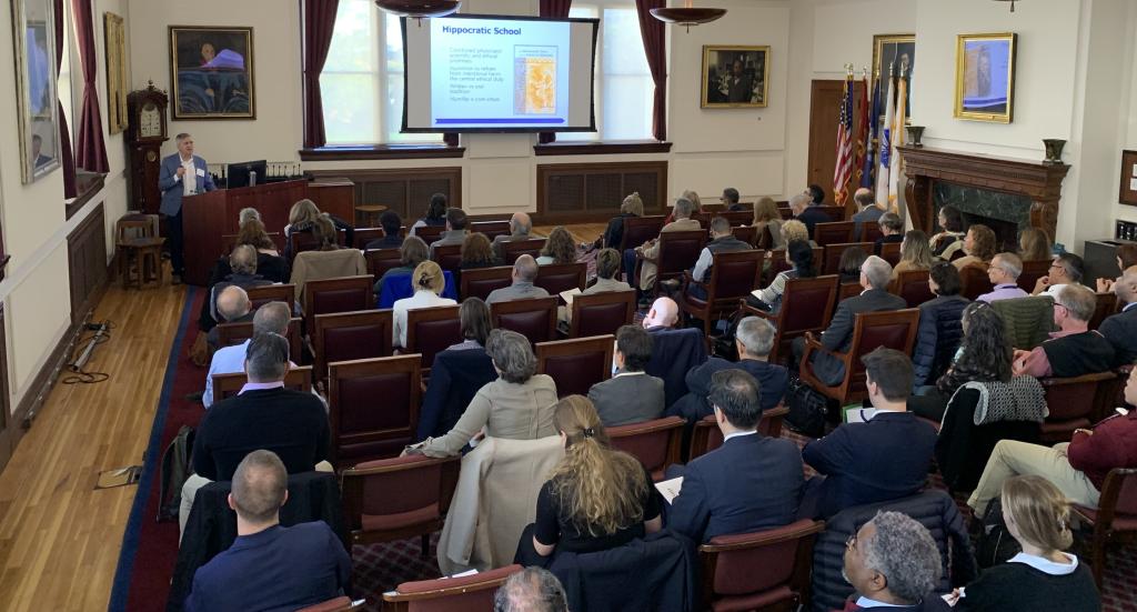 Audience watches a presentation in Waterhouse Room.