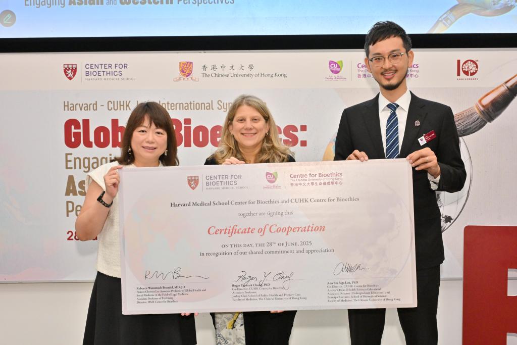 Lau, Brendel and Chung holding giant certificate of cooperation.