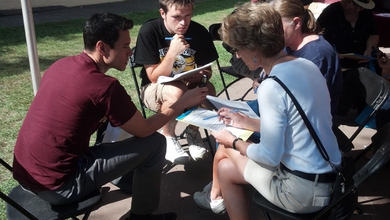 Dr. Shen and others sitting outside and conducting research