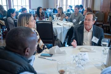 Ed Hundert talks with a small group of Summit participants.