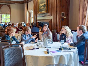 Summit participants talking in small groups.