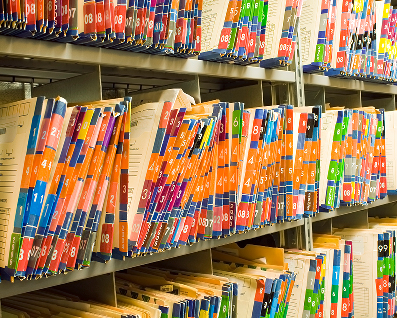 Rows of colorful medical records and patient charts.